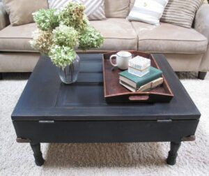 Coffee table made from an old door and painted black.